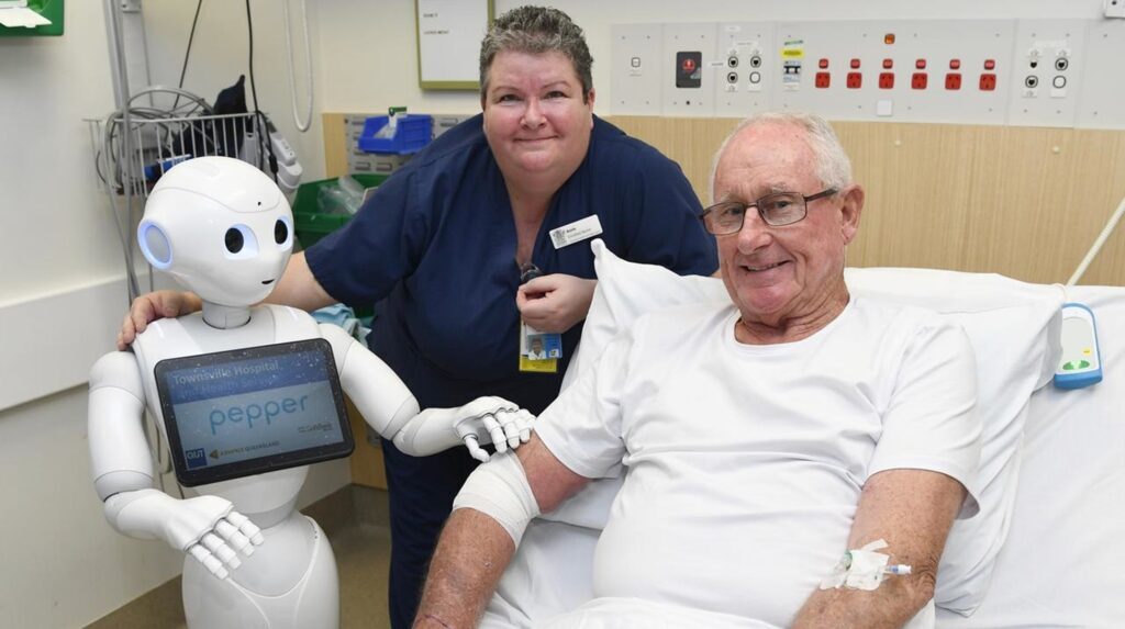 Image of Pepper, a healthcare robot, assisting an elderly patient.  
